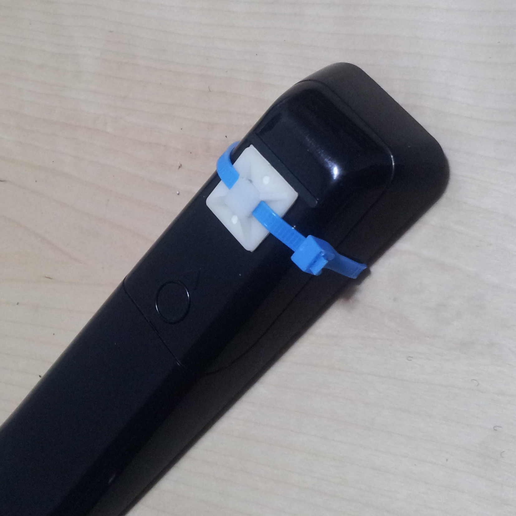 cable tie mount is on the cover. remote still sits upright